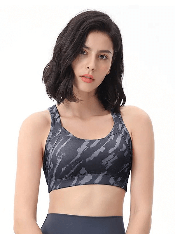 Woman wearing Stylish Elastic Sports Bra with Cross Back, offering breathable comfort and adjustable support for workouts.